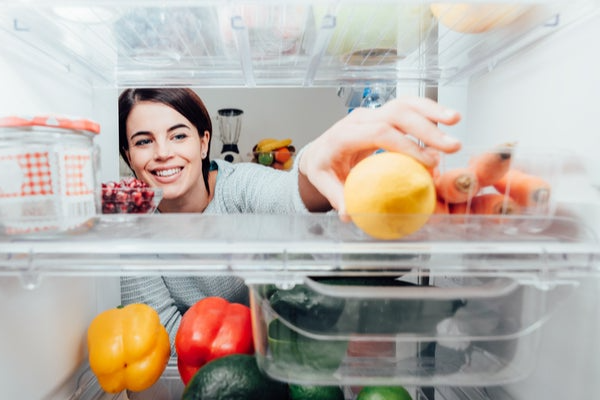 reaching into refrigerator